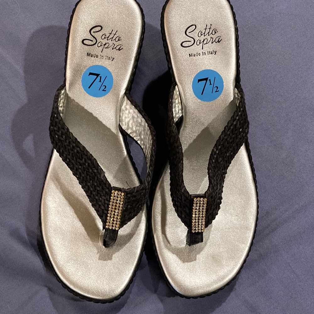 Black wedges with rhinestone detail at the thong
